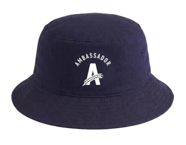 Navy blue bucket hat with a white embroidered logo on the front featuring the word ‘Ambassador’ above a large Athletic Brewing ‘A’ logo. The hat is shown against a light gray background.
