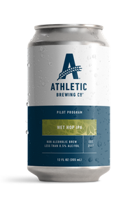 Athletic Brewing Company Pilot Program Wet Hop IPA 12 oz non-alcoholic beer can featuring a white and navy blue label with a green hop-inspired design, Athletic Brewing logo, and less than 0.5% alcohol by volume.