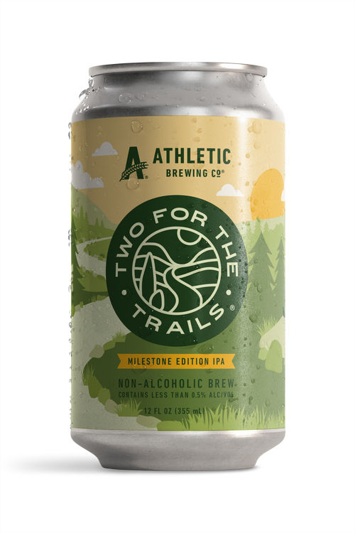 Condensation-covered can of Athletic Brewing Two for The Trails Milestone Edition IPA. The label features a stylized green forest landscape.