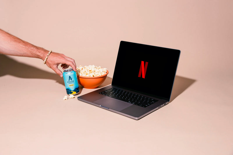 Netflix on laptop and Run Wild beer can with popcorn next to it